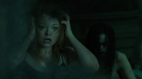 Jessie sees a ghost in the reflection of a cloudy old mirror.