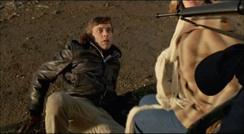 Peter instructs Stephen on the finer points of gun safety.