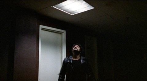 A raider (Tom Savini) sees Peter's escape route.
