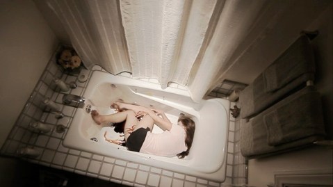 Lily lies bleeding in Bernadette's bathtub.